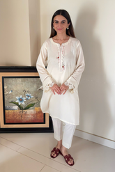 Ready-to-wear linen dress with intricate neckline and sleeve embroidery, ideal for winter wear