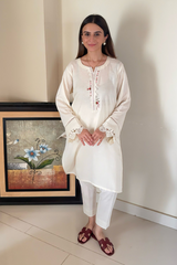 Ready-to-wear linen dress with intricate neckline and sleeve embroidery, ideal for winter wear