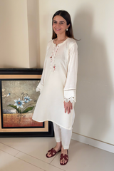 Ready-to-wear linen dress with intricate neckline and sleeve embroidery, ideal for Summer wear.